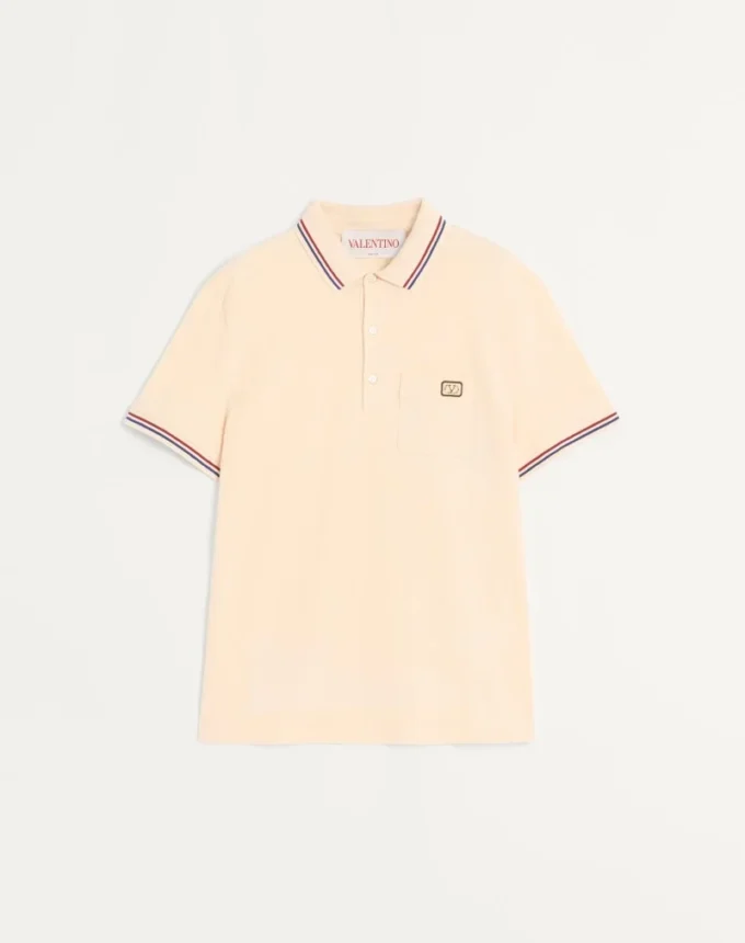Bawełniana koszulka polo z pikowanym materiałem i naszywką z logo Bawełniana koszulka polo z pikowanym materiałem i naszywką z logo