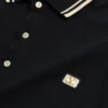 Bawełniana koszulka polo z pikowanym materiałem i naszywką z logo Bawełniana koszulka polo z pikowanym materiałem i naszywką z logo