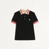 Bawełniana koszulka polo z pikowanym materiałem i naszywką z logo Bawełniana koszulka polo z pikowanym materiałem i naszywką z logo