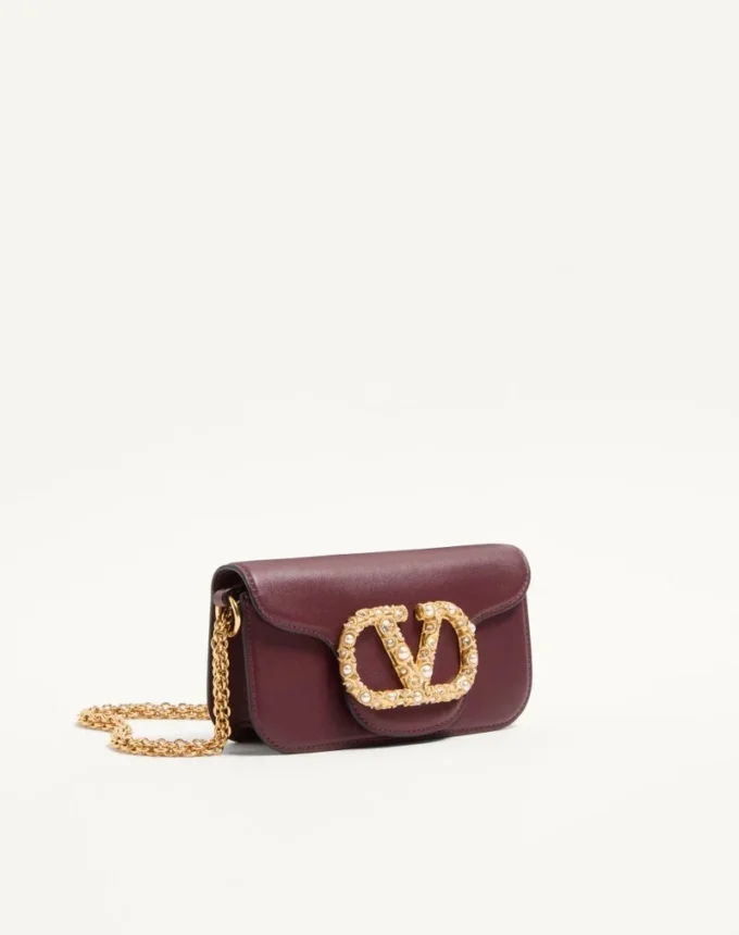 Mała torebka na ramię Valentino Garavani Locò z cielęcej skóry z logo Jewel Mała torebka na ramię Valentino Garavani Locò z cielęcej skóry z logo Jewel