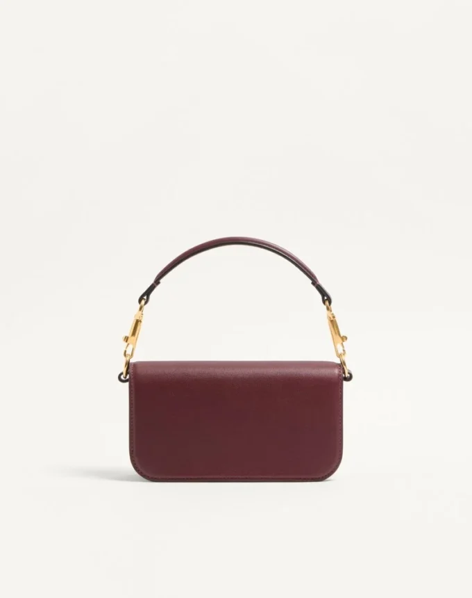 Mała torebka na ramię Valentino Garavani Locò z cielęcej skóry z logo Jewel Mała torebka na ramię Valentino Garavani Locò z cielęcej skóry z logo Jewel